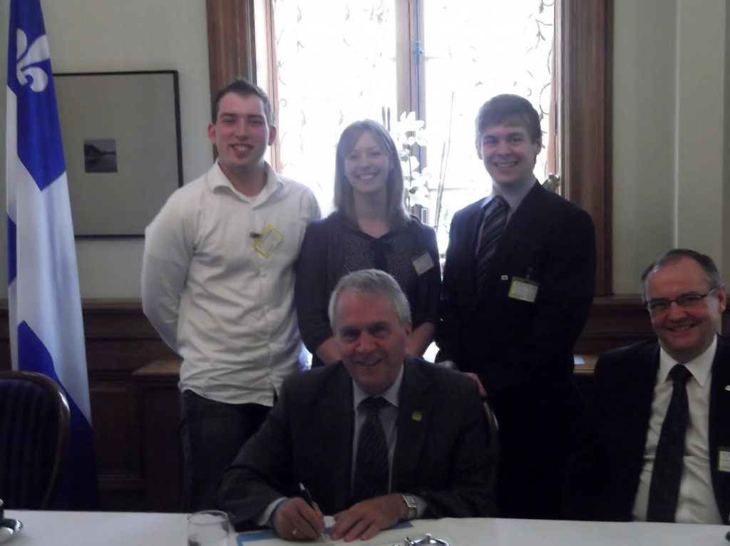 Quebec 4-H President Mathieu Rouleau and AJRQ President Marie-Pier Vincent along with a representative from the FRAQ were pleased to have Minister of Agriculture Francois Gendron sign a declaration to acknowledge the importance of the rural youth movement.  